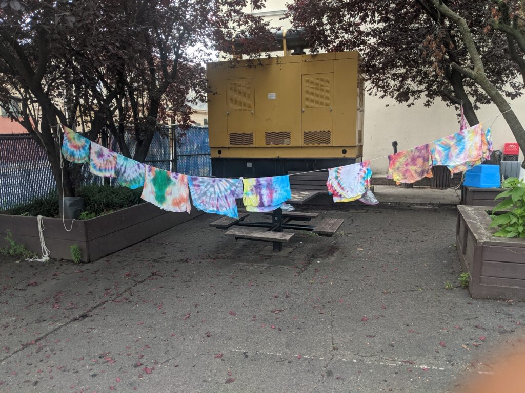 Tie-dyed t-shirts, drying on a clothesline outside of Covenant House PA