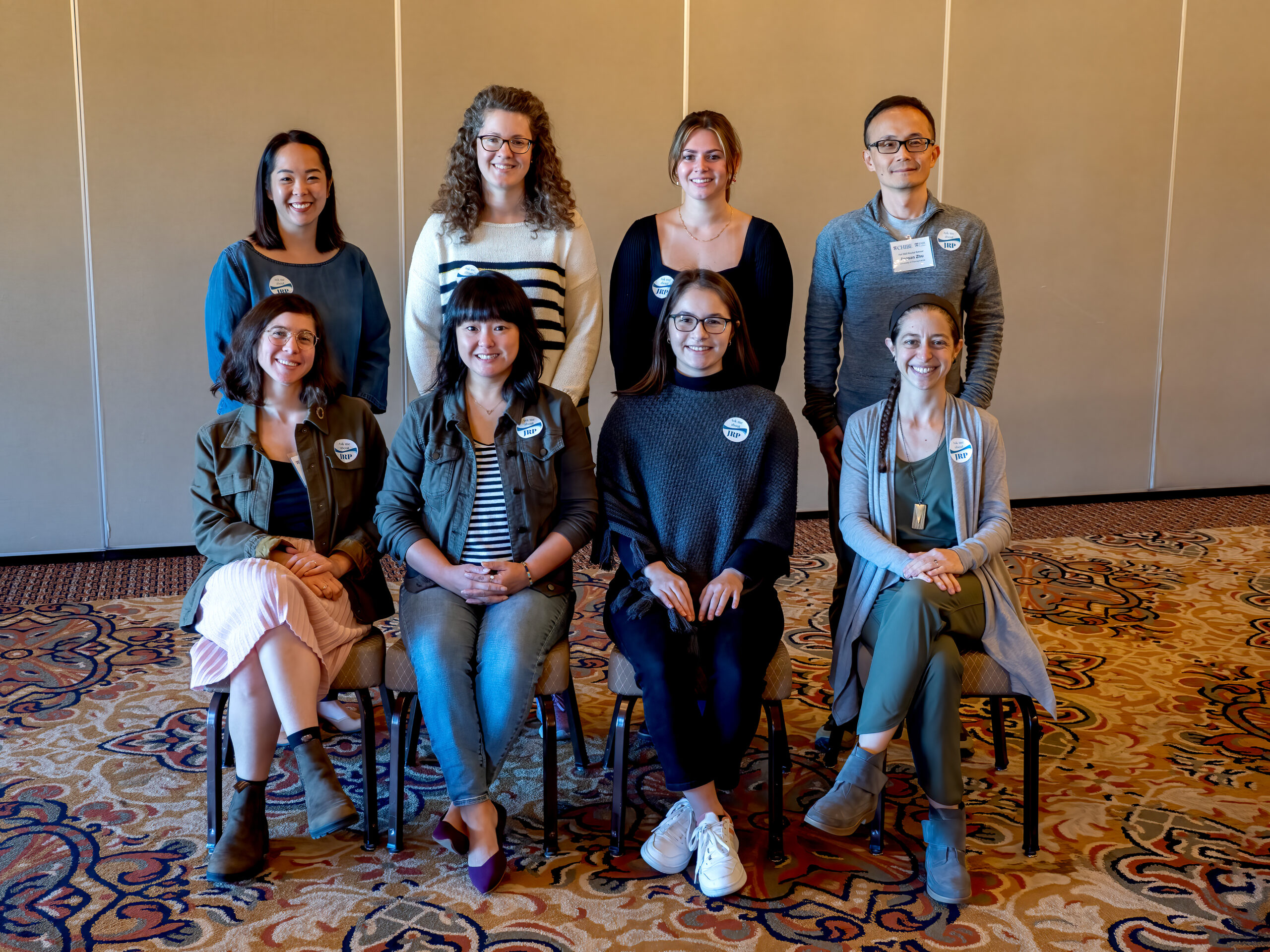 Four people seated and four others standing behind them for group photo of the JRP Working Group for equitable research and inclusive research