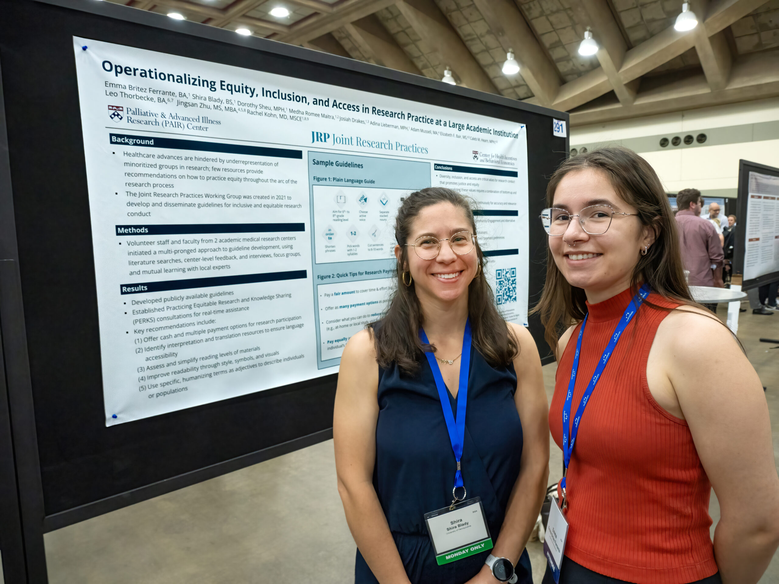 Shira Blady and Emma Britez Ferrante pose next to their poster: "Operationalizing Equity, Inclusion, and Access in Research Practice at a Large Academic Institution."