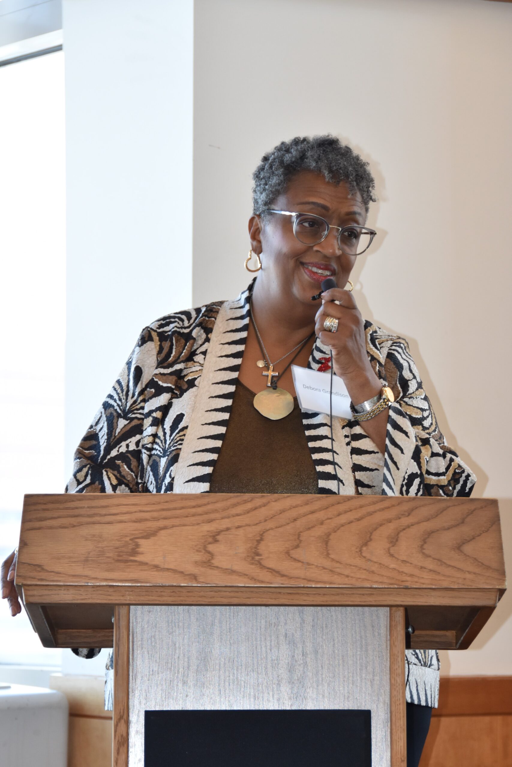 Debora Grandison speaks at the podium.