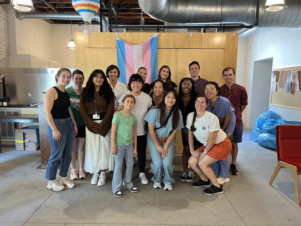 Fifteen volunteers from the PAIR Center stand for a photo inside the Penn LGBT Center.