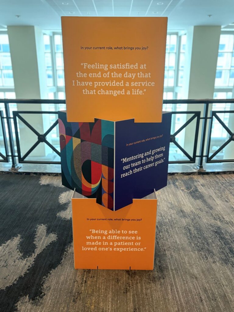 Photo of signs at the CAPC National Seminar that read 'In your current role, what brings you joy?" With responses: "Feeling satisfied at the end of the day that I have provided a service that changed a life." "Mentoring and growing our team to help them reach their career goals." "Being able to see when a difference is made in a patient or loved one's experience."