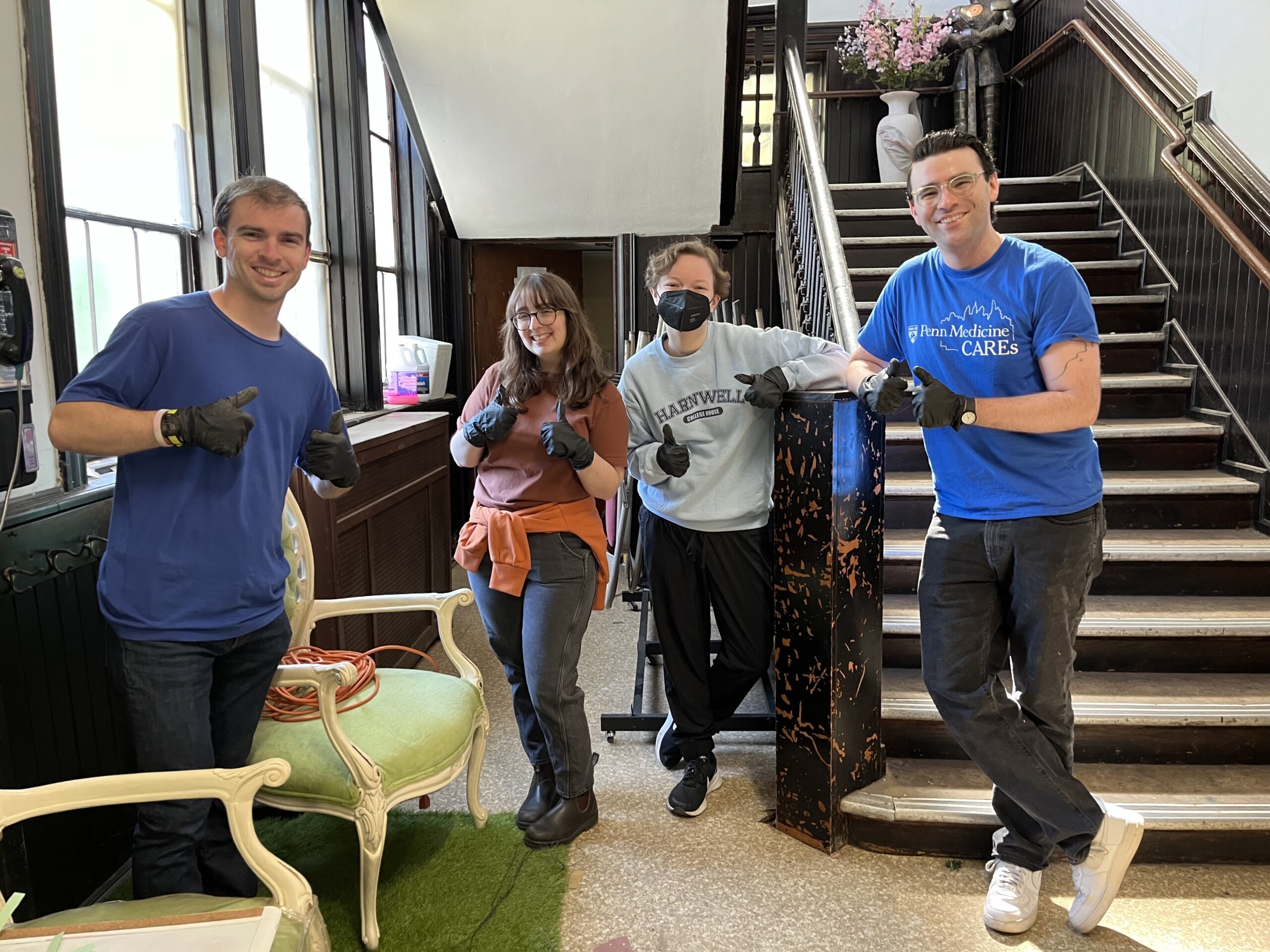 Benjamin Schmid, Emily Campbell, Ellie McKeown, and Conor Shatton give a thumbs up as they clean at Harmony House.